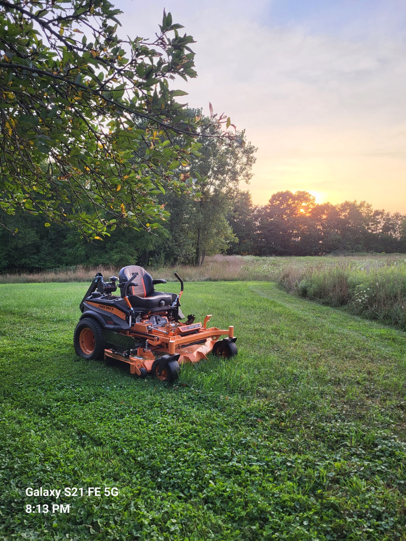 Scag Cheetah II zero-turn mower on a freshly cut Mid-Michigan field at sunset
